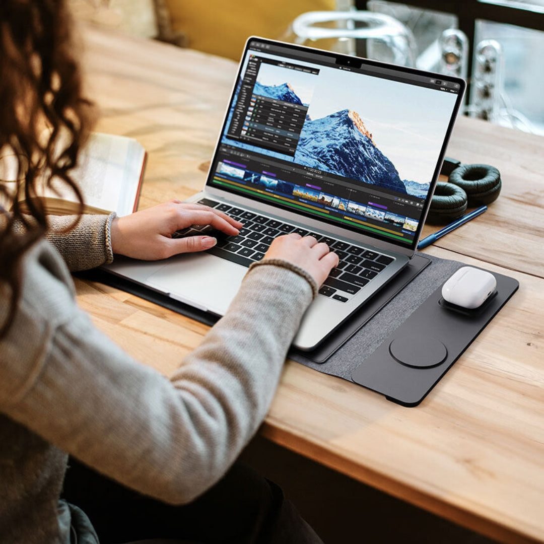 A Chemistors laptop sleeve, stand and wireless charging desk mat in use at a desk